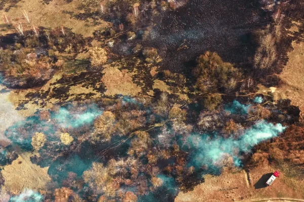 Aerial view spring dry grass burns during drought