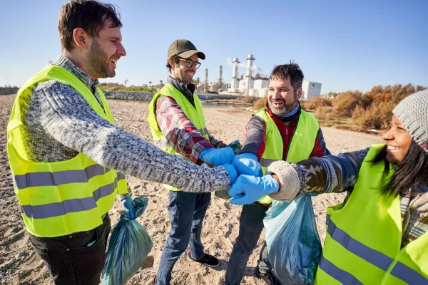 Smiling volunteers clean beach